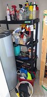 Full shelving unit with assorted car care items, buckets on floor