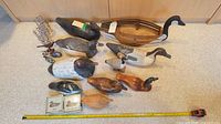 Entire lot laid out with measuring tape for scale showing all decoys, wooden carrier and coasters