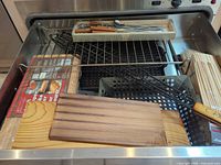 Drawer with cedar planks, perforated basket, racks, skewers and utensils