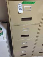 Front view of beige four-drawer filing cabinet