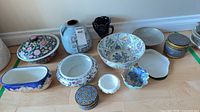 Group shot of all porcelain and ceramic pieces lined against wall