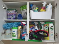 Cabinet with assorted cleaning supplies