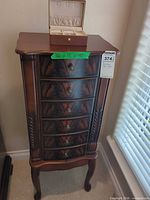 Full view of jewelry armoire with travel box on top