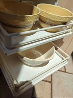 Beige ceramic bowls on rack