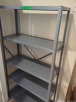 Full view of gray steel shelving unit with five shelves