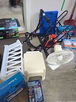 Overview showing stool, shoe rack, fan, ab roller, dolly, cable reel and boxed items