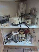 Overall view of all three appliances and accessories on cabinet shelves