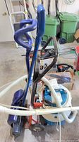 Group showing shampooer, dolly, snow shovel and hoses
