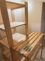 Tall and small unfinished pine shelving racks