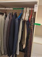 Closet rod with multiple blazers, trousers and ties