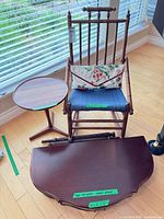 Overview of rocking chair, side table, scalloped table top and pillow