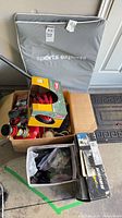 Overview of lot with mat, boxes, helmet box, skates box