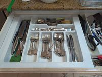 Drawer tray with assorted forks, spoons, knives