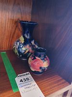 Both Moorcroft vases on shelf showing size and decoration