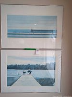 Pair of framed landscape prints hung vertically