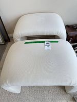 Both ottomans top view with lot sticker visible