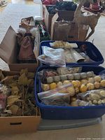 Assorted ornaments, ribbons, foliage, angel topper in totes and boxes