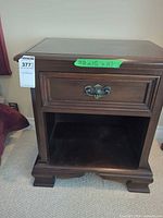 Front view showing drawer, open shelf, bracket feet