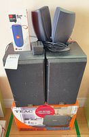 Front view of TEAC speakers with T&G speaker box, power adapter and cables