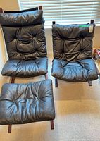 Both chairs and ottoman front view showing overall design and wear