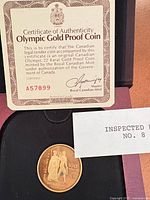 Coin in case with certificate and inspection slip numbered A57899 visible