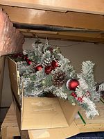 Boxed flocked swag with pinecones, red ornaments, berries and eucalyptus