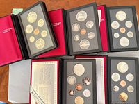 All five open proof sets showing coins and cases