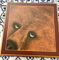 Top view of wood jewelry box showing painted bear panel, burgundy border, gold trim