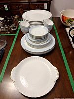 Overall view of stacked plates, cups and serving plate