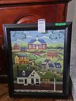 Full view of framed folk landscape print in black frame