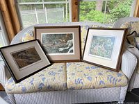 Front view of all three framed prints on sofa