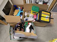 Overview of three boxes with assorted cleaning and automotive products
