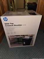 Front of sealed box showing HP Slide Top Crosscut Shredder CC16 image and specifications