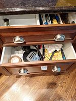 Open drawers showing utensils quantity and variety