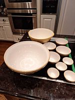 Full set of Mason Cash ceramic mixing bowls in nested sizes displayed on kitchen island