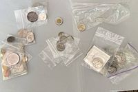 Overview of mixed coins in bags and flips