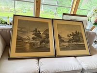 Pair of framed monochrome Japanese landscape prints on sofa