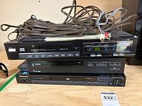 Stacked view of LX1 CD player, Philips display, Pioneer DVD player with coiled speaker wire and RCA cables