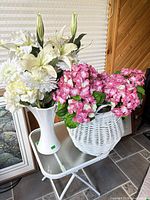 Overall lot showing table, vase with white flowers, basket with pink flowers