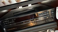 Front view of Sony CDP-C445 CD player with remote on top