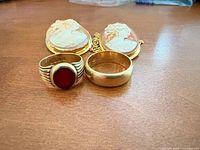 Group shot of cameo pendant and two rings