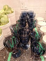 Group of ten blue glass goblets on countertop