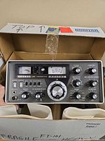 Front view of Yaesu FT-101 transceiver in original box with foam inserts