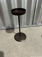 Full view of candle holder showing pedestal form and finish