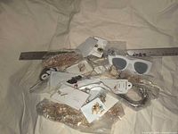 Lot overview showing assorted jewelry in bags and SojoS sunglasses