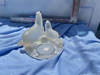 Front view of frosted glass seal and pup figurine on circular base