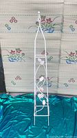 Full view of white metal trellis obelisk