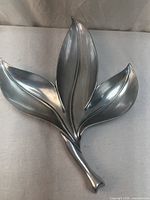 Front view of silver-plated three-lobed banana leaf dish