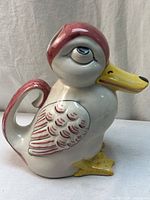Left side view of duck pitcher showing handle, wing detail, and overall form