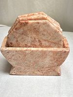 Front view showing rose pink marble holder with coasters inside